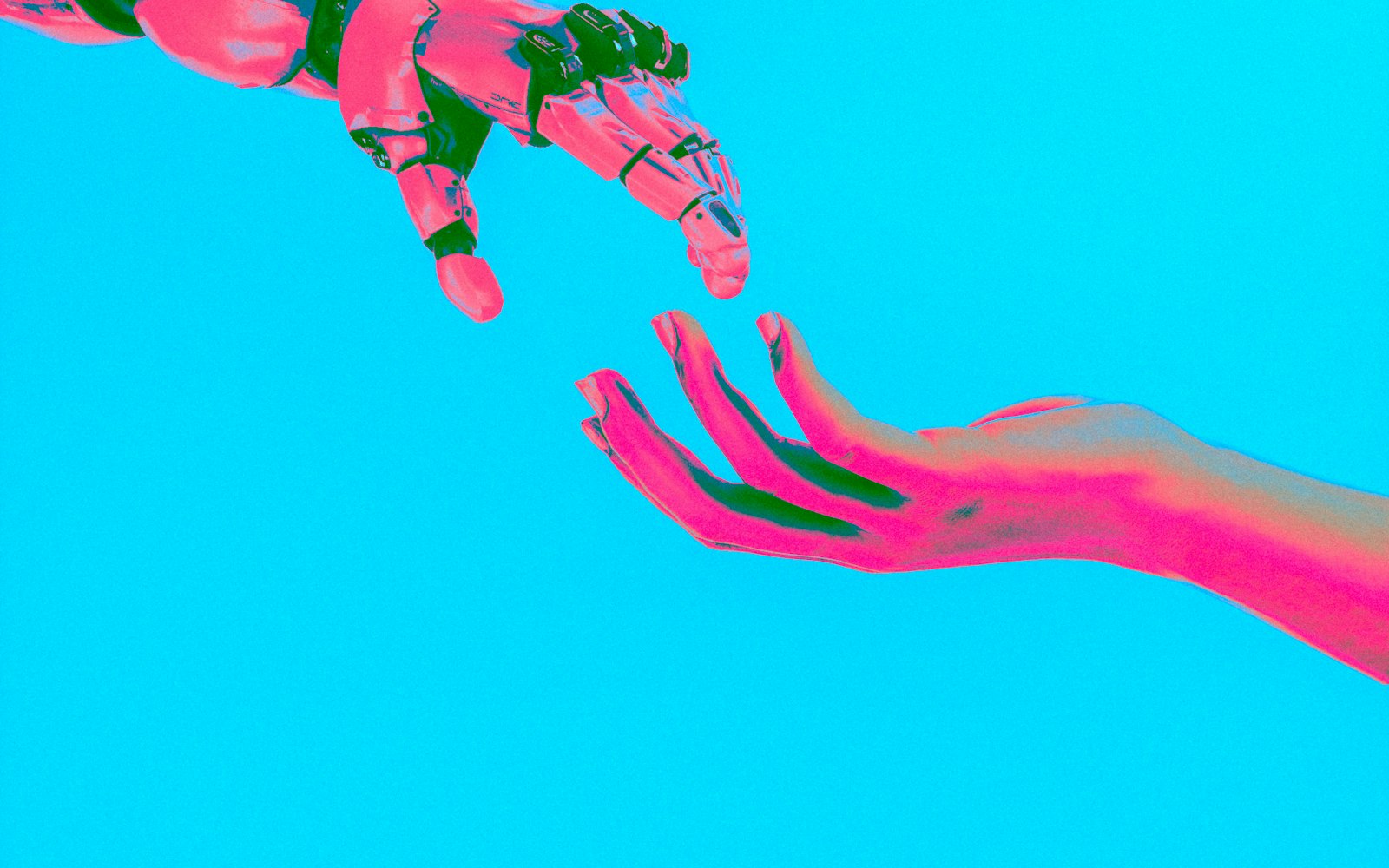 A robotic hand and a human hand reaching toward each other